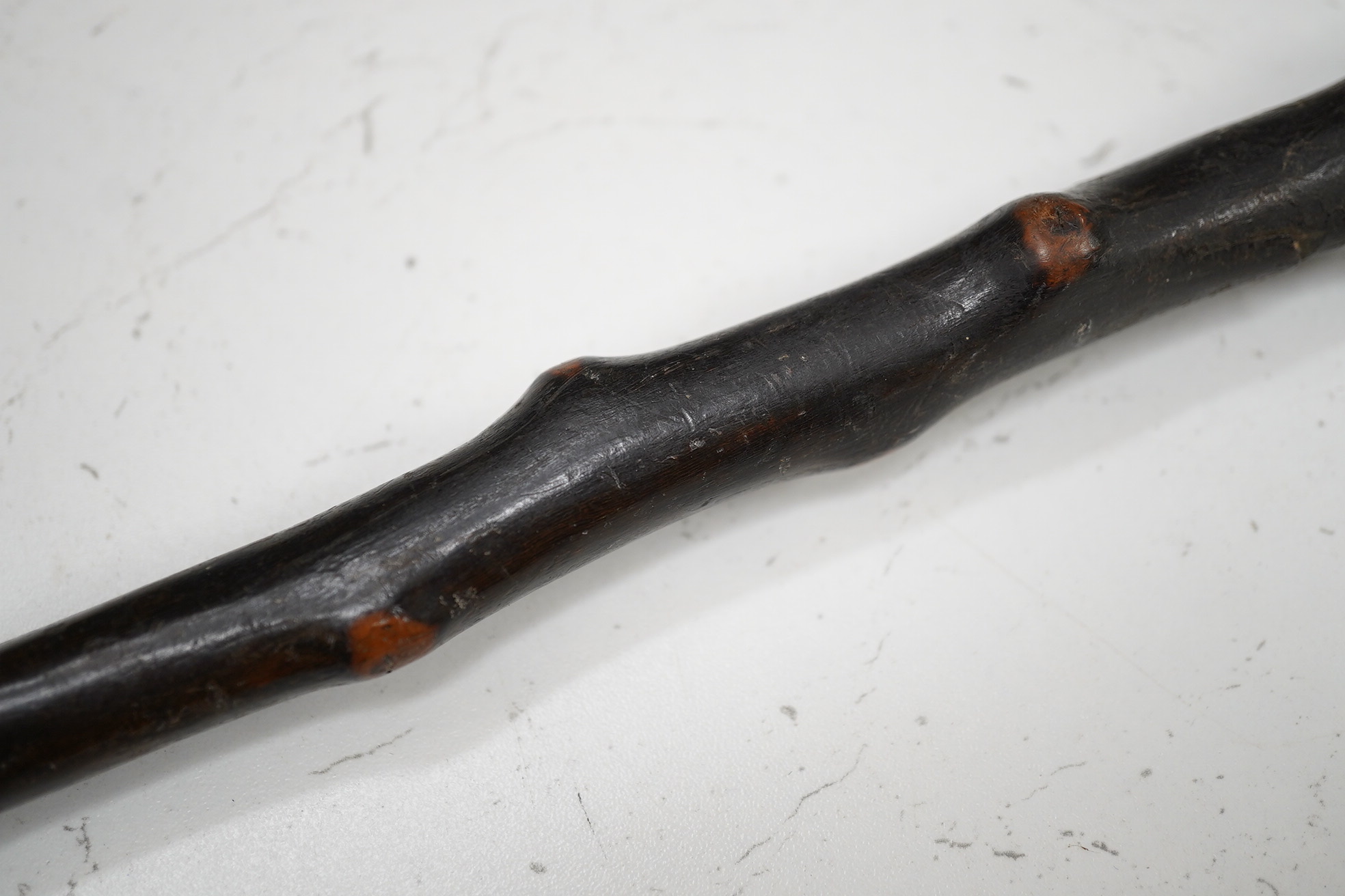 A carved rootwood walking stick, with carved novelty ‘Punch’ style head handle. 81cm high. Condition - some damage on stick.